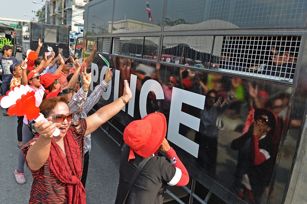 Para pendukung Yingluck Shinawatra menari dan bersorak usai menutup gerbang KPK Thailand -- Manjunath Kiran / AFP