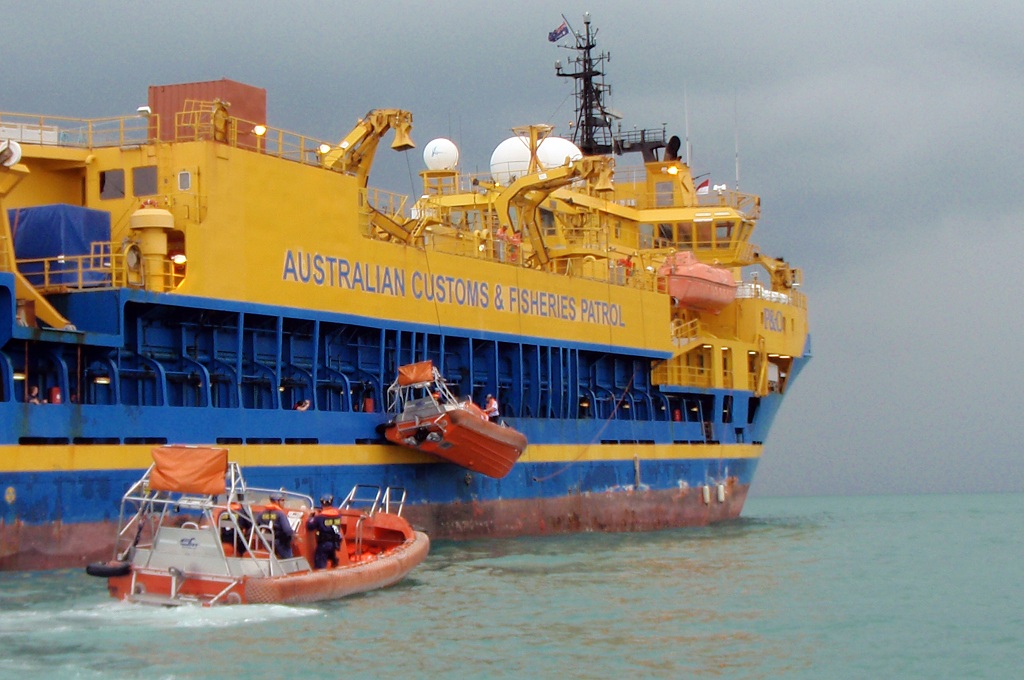 Sri Lankan asylum seekers disembark on a rubber boat from the Australian Customs ship Ocean Viking and transferred to a waiting Indonesian ferry off the island of Bintan near Singapore on November 18, 2009, to be taken to the Indonesian immigration detent