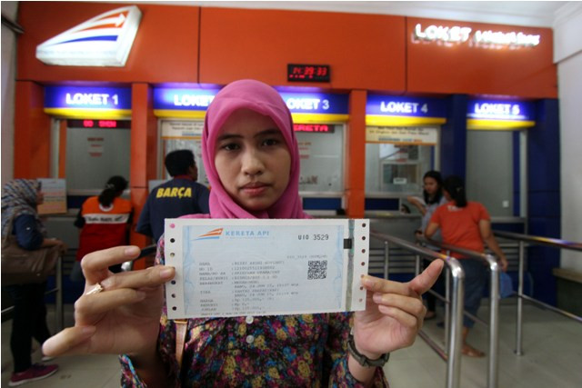 Penumpang menunjukkan tiket kereta api. (Foto: Antara/Septianda Perdana)