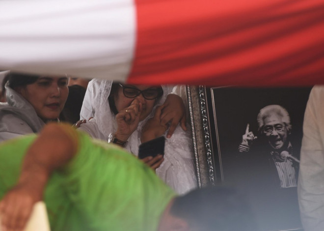 Kerabat menangis saat berlangsungnya pemakaman almarhum Adnan Buyung Nasution di TPU Tanah Kusir, Jakarta, Kamis (24/9/2015). Foto: Akbar Nugroho Gumay/Antara