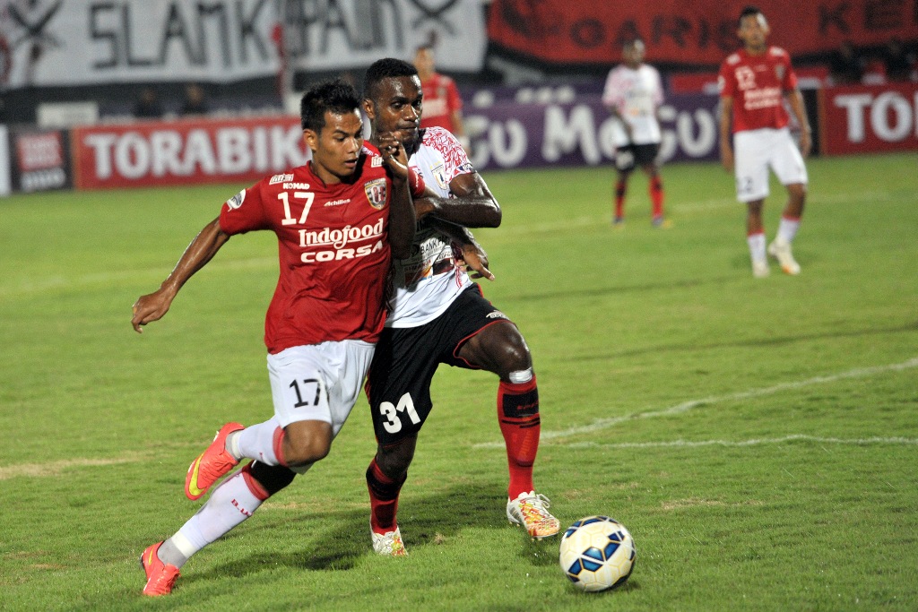 Pesepak bola Persipura Jayapura Dominggus Fakdawer (kanan) berebut bola dengan pesepak bola Bali United, Sukarja (kiri) dalam pertandingan Babak Penyisihan Grup B Sepak Bola Piala Jenderal Sudirman di Stadion Wayan Dipta (ANTARA FOTO/Nyoman Budhiana)