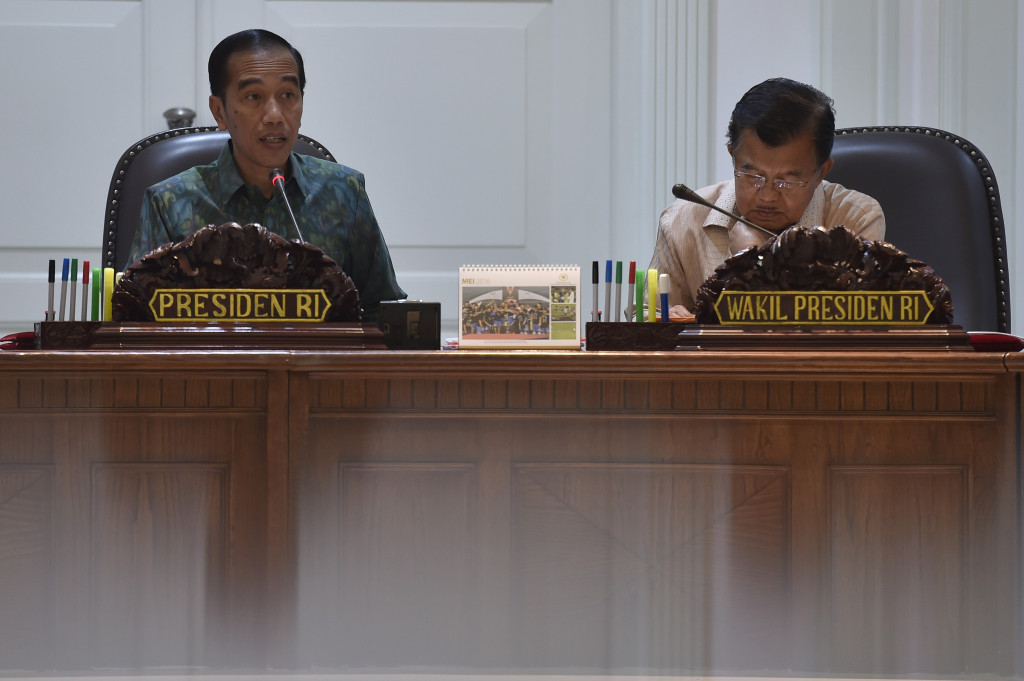 Presiden Jokowi (Kiri). ANTARA FOTO/Puspa Perwitasari.