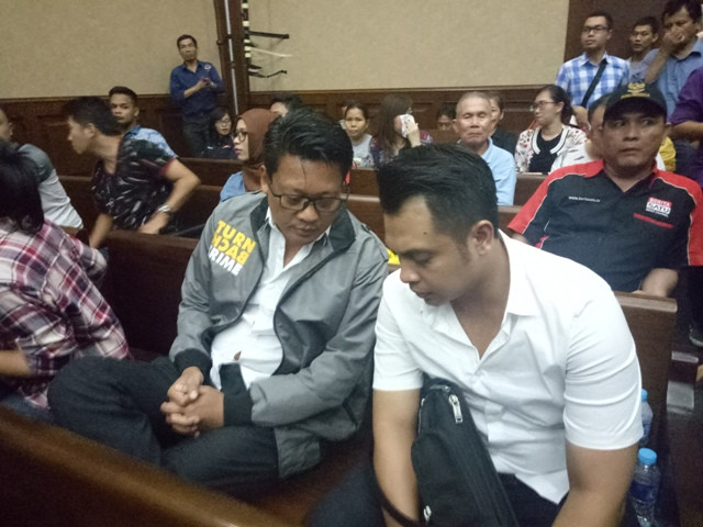 Mantan Direktur Reserse Kriminal Umum Polda Metro Jaya Kombes Krishna Murti tengah berbincang dengan Kanit I Subdit Jatanras Ditreskrimum Polda Metro Jaya, AKP Hendro di Pengadilan Negeri Jakarta Pusat. Foto: Arga Sumantri/Metrotvnews.com. 