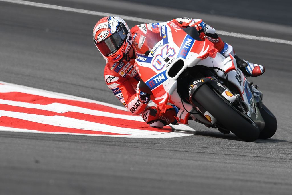 Andrea Dovizioso sedang menaklukkan salah satu tikungan di Sirkuit Sepang. (AFP PHOTO / MOHD RASFAN)