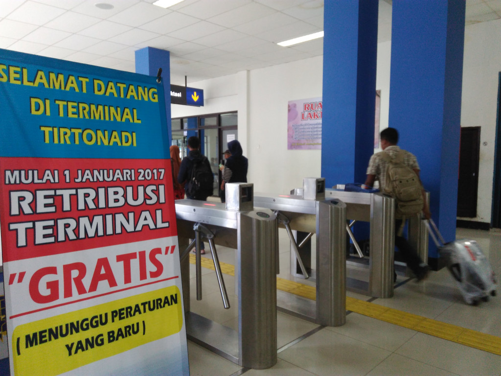 Pengumuman penggratisan retribusi yang dipasang di Terminal Tirtonadi Solo, Minggu (01/01/2017).
