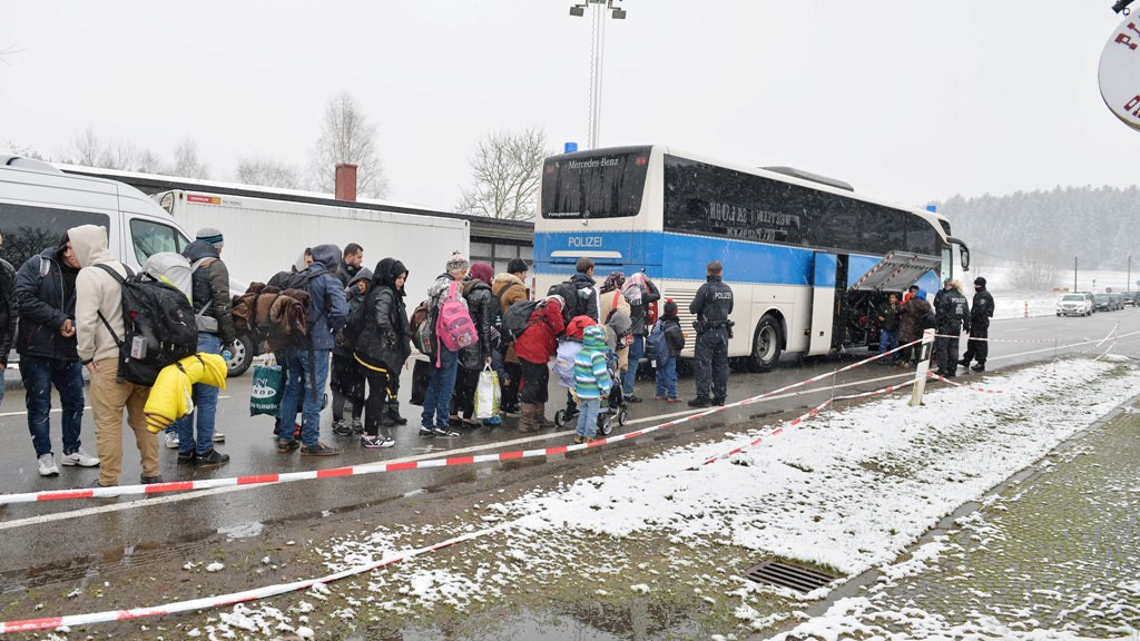 Migran mengantre untuk naik bus setelah melintasi perbatasan antara Austria dan Jerman di Wegscheid dekat Passau, Jerman (22/22/2015). (AP Photo/Kerstin Joensson).