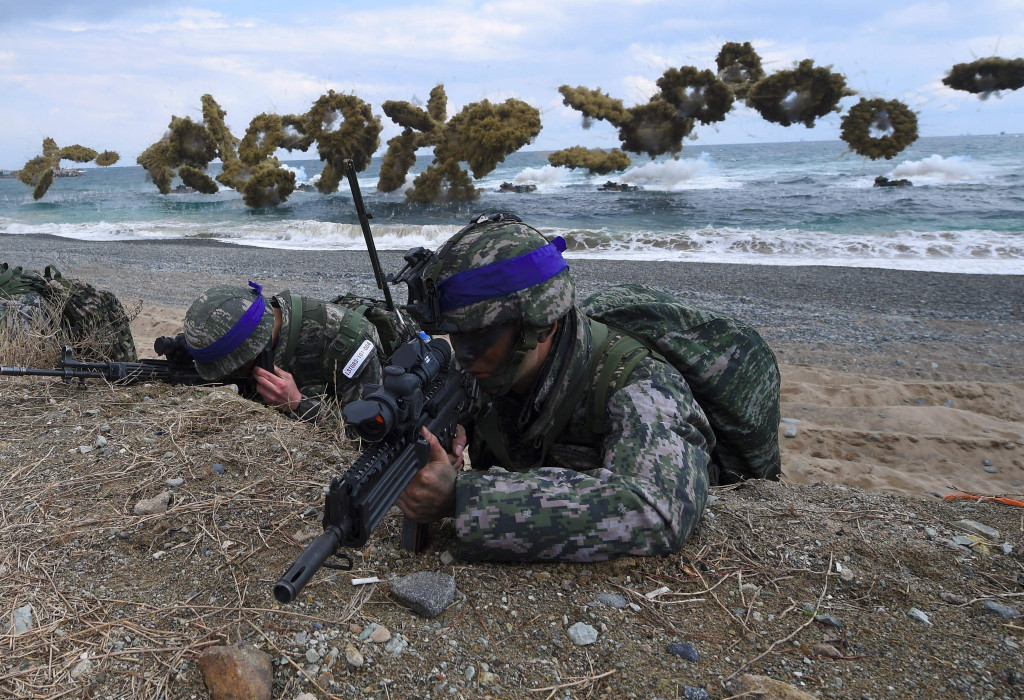 South Korean Marines take position on a beach as amphibious assault vehicles fire smoke shells during a joint landing operation by US and South Korean Marines in the southeastern port of Pohang on April 2, 2017. (Photo:AFP/Jung Yeon-Je)