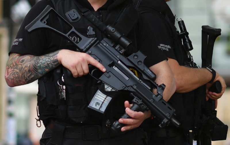 Armed police stand secure a street in central Manchester, on May 24, 2017 (Photo:AFP/Ben Stansall)