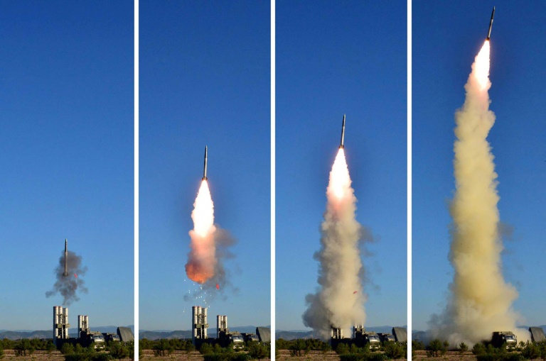 This combo shows undated pictures released from North Korea's official Korean Central News Agency on May 28, 2017 of the test of a new anti-aircraft guided weapon system organized by the Academy of National Defence Science at an undisclosed location. (Ph