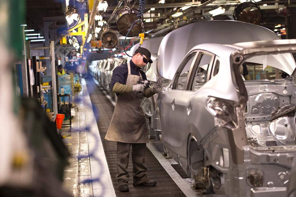 A member of Japan automotive manufacturing staff working on the production line  at the Sunderland Plant in Sunderland, North East England (Photo: AFP).