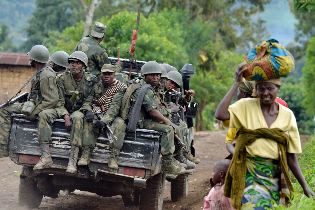 This file photo taken on November 4, 2013 towards the Mbuzi hilltop near Rutshuru shows Armed Forces of the Democratic Republic of Congo (FARDC) soldiers sitting at the back of a pick-up truck. (Photo:AFP/Junior D Kannah)