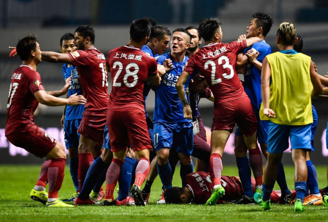 Momen saat terjadinya keributan antar pemain yang dipicu oleh aksi indisipliner Oscar (terjatuh) di Liga Super Tiongkok (Foto: AFP PHOTO / STR / China OUT)