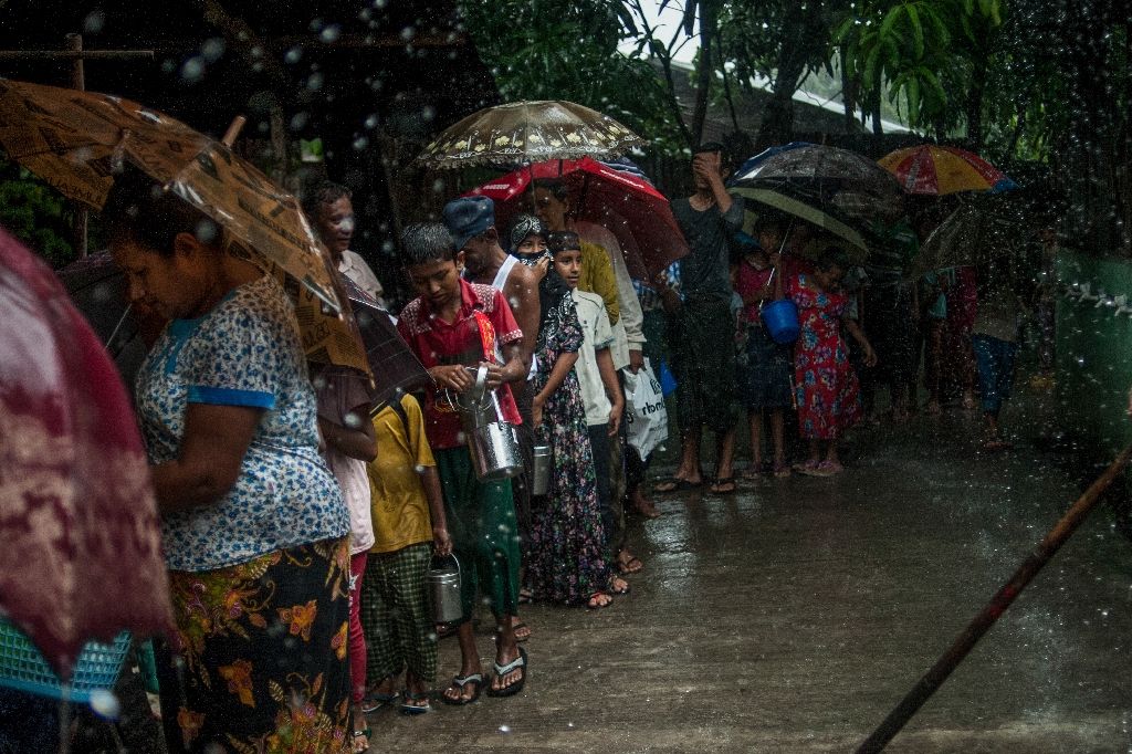 Dozens of Muslims stand in line at a mosque during a monsoon downpour in Yangon, waiting for a small portion of rice and curry to break their fast during the holy month of Ramadan (Photo:AFP/Ye Aung Thu)