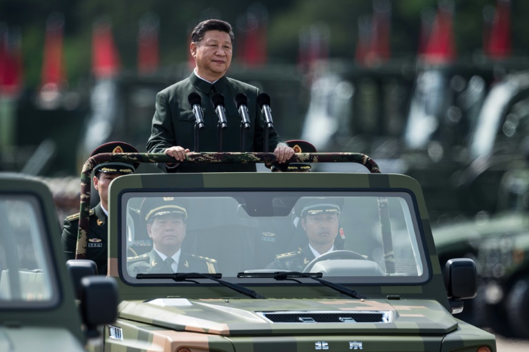 China's President Xi Jinping wore a Mao suit as he was driven in an open-top jeep past serried ranks of the People's Liberation Army, in a rare show of force in Hong Kong. (Photo:AFP/Dale De La Rey)