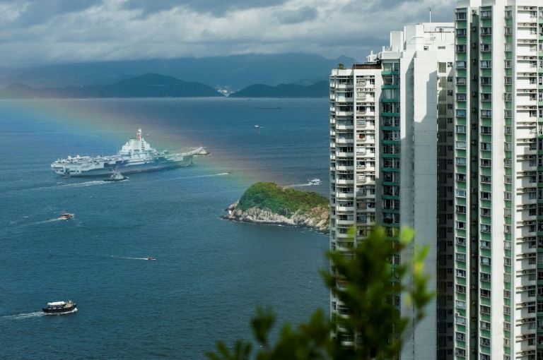 The 305 metre-long (1,000 feet) Liaoning, a secondhand Soviet ship built nearly 30 years ago and commissioned in 2012, arrived in Hong Kong early Friday, as a rainbow appeared overhead. (Photo:AFP/ Richard A. Brooks)