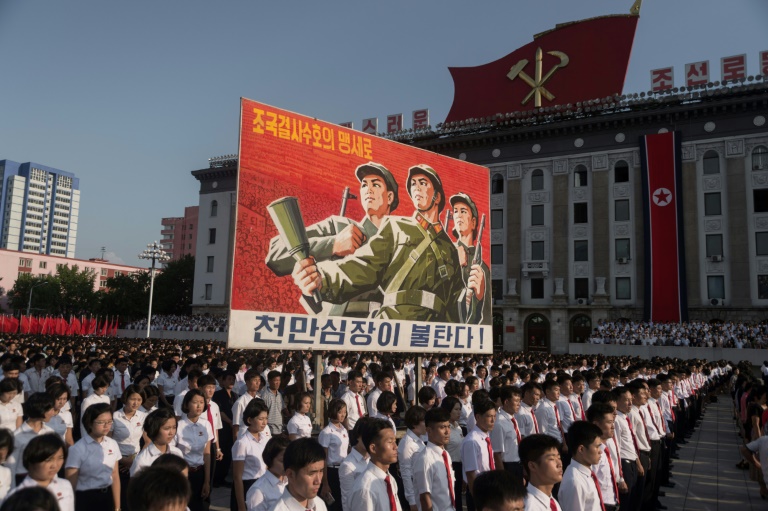 North Koreans wave banners and shout slogans at a state organised anti-American rally in Pyongyang. (Photo:AFP/Kim Won Jin)