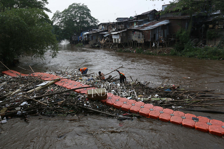 Tumpukan Sampah dan Kayu Hambat Aliran Sungai Ciliwung