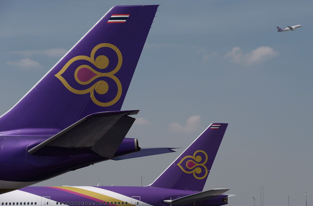This file photo taken on November 24, 2014 shows a Thai Airways aircraft taking off past the tails of two other Thai Airways planes at Bangkok's Suvarnabhumi international aiport.(Photo:AFP/Christophe Archambault)