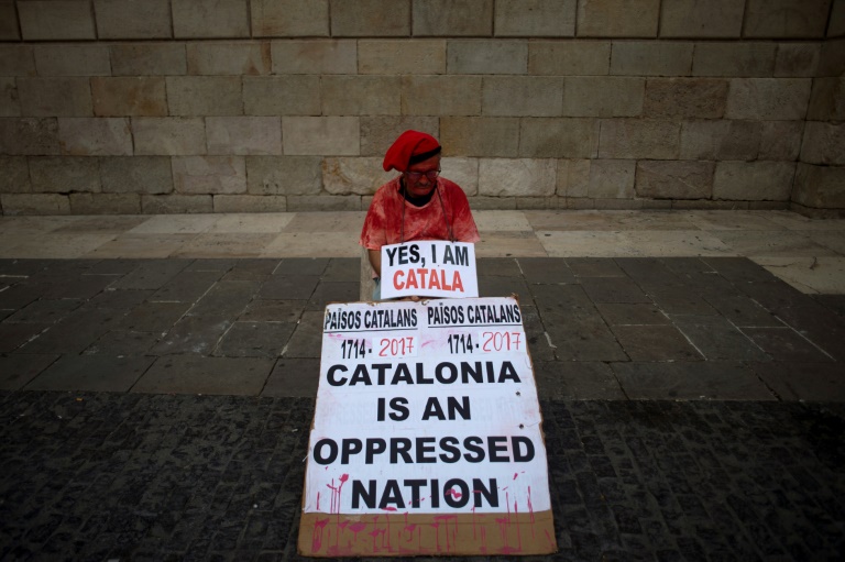 A man holds a placard reading 