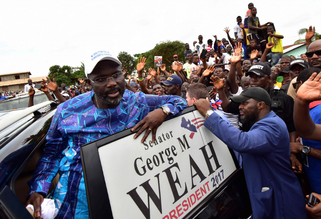Former international Liberian football star turned politician George Weah, greets supporters during a campaign rally in Monrovia on October 8, 2017, three days ahead of the country's elections.  (Photo:AFP/Issouf Sanogo)