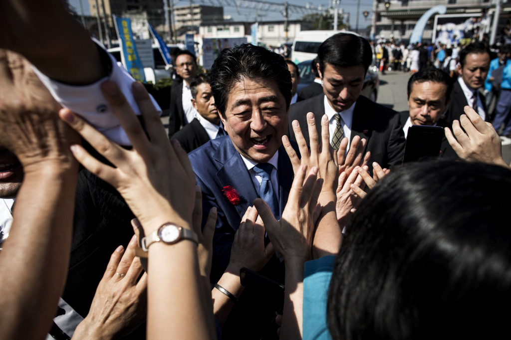 Japan's Prime Minister and ruling Liberal Democratic Party (LDP) president Shinzo Abe greets supporters during an election campaign in Yaizu, Shizuoka prefecture, on October 11, 2017. (Photo:AFP/Behrouz Mehri)