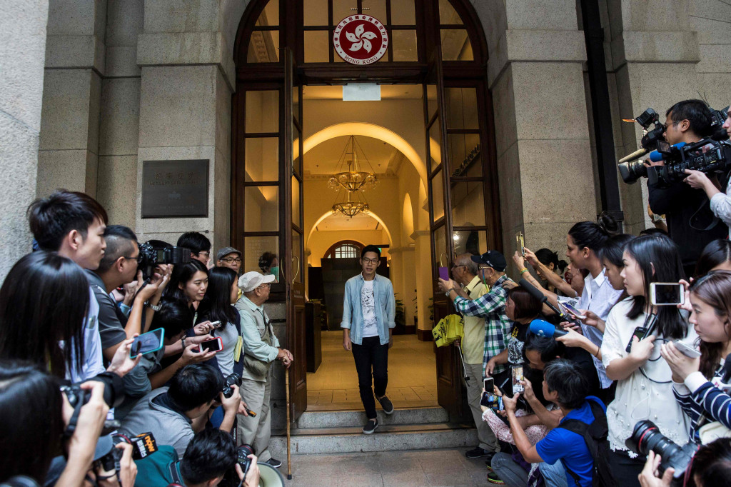 Pro-democracy activists Nathan Law walks out of the Court of Final Appeal after he and Joshua Wong's (not pictured) bail application were successful at Hong Kong's highest court on October 24, 2017. (Photo:AFP/Isaac Lawrence)