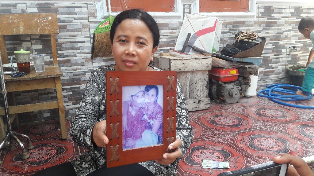 Kakak Masamah, Masiroh, memegang foto Masamah dan Suaminya