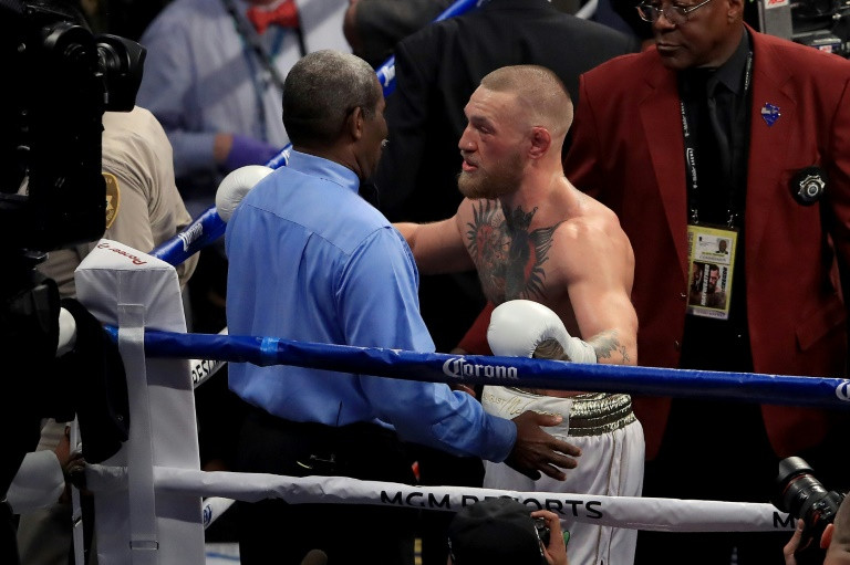 Conor McGregor, seen here speaking to referee Robert Byrd after losing to Floyd Mayweather in their super welterweight boxing match in August, 2017, at T-Mobile Arena in Las Vegas, Nevada, attacked a shuttle bus carrying fighters in New York. (Photo:AFP/G