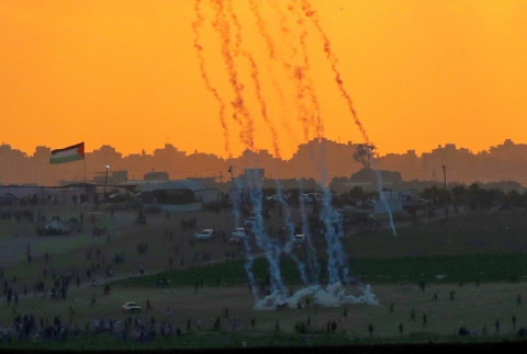 Tear gas rises amidst Palestinian protesters during clashes