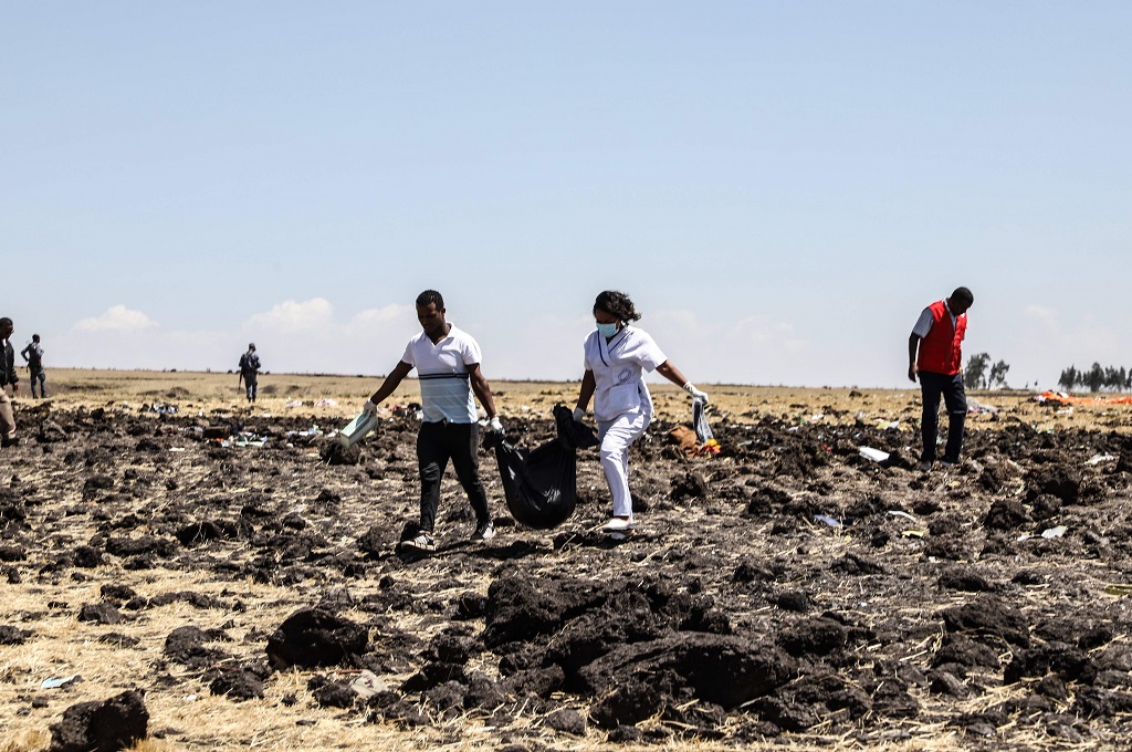 Petugas mengangkut jasad para korban kecelakaan pesawat Ethiopian Airlines di dekat kota Bishoftu, Ethiopia, 10 Maret 2019. (Foto: AFP/MICHAEL TEWELDE)