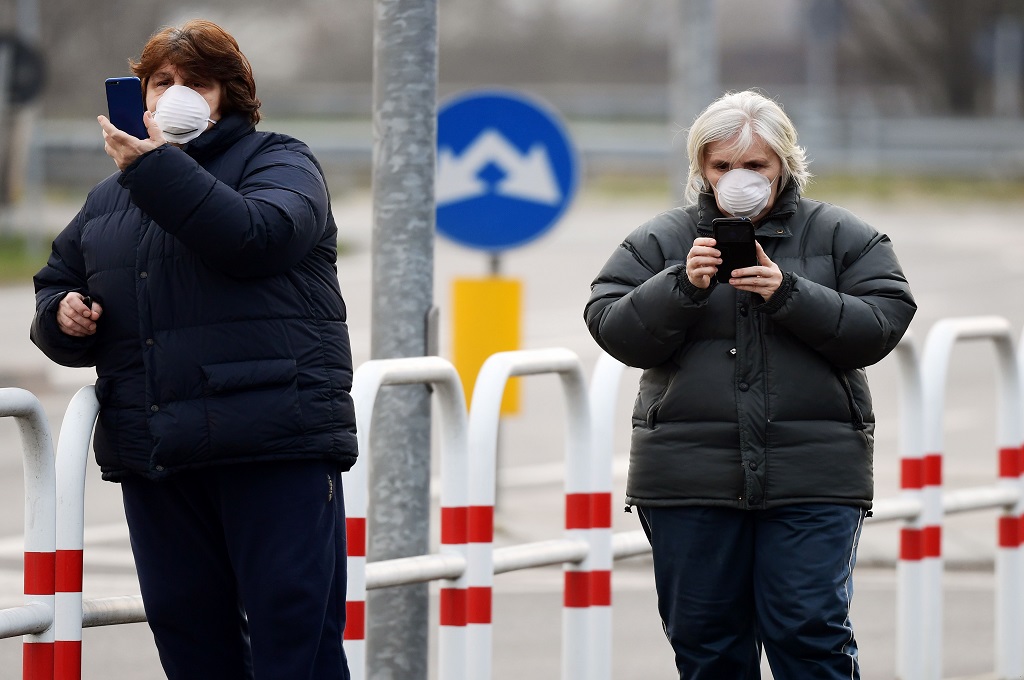 Warga mengenakan masker saat beraktivitas di kota Casalpusterlengo, Italia, 23 Februari 2020. (Foto: AFP/MIGUEL MEDINA)