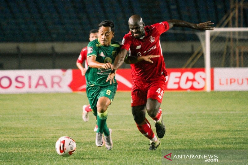 Penyerang Persebaya Surabaya Samsul Arif (kiri) berduel dengan pemain belakang Persik Kediri Ok John. (ANTARA/HO-Official Persebaya Surabaya)