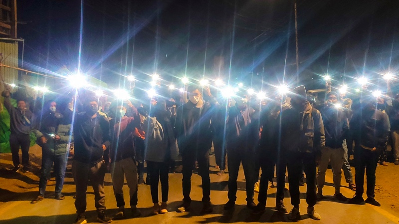 Para pemuda di wilayah Hakka, Myanmar menyalakan lampu di telepon selular dalam sebuah aksi protes. Foto: AFP