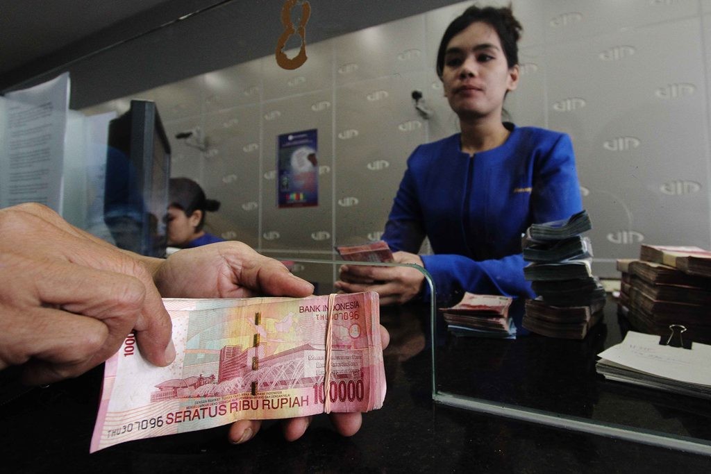 Ilustrasi transaksi menggunakan mata uang Rupiah - - Foto: MI/ Angga Yuniar