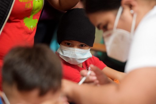 Children receives covid-19 vaccine shot. Photo: AFP