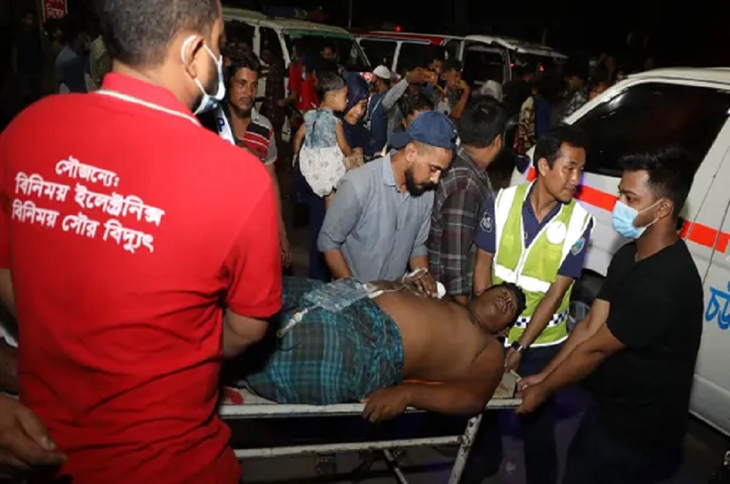 Petugas mengangkut korban luka dari lokasi kebakaran di sebuah depot kontainer di Sitakunda, Bangladesh pada Minggu dini hari, 5 Juni 2022. (AFP/Getty)