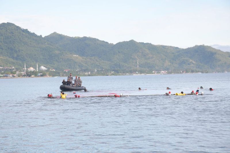 Pengibaran bendera Merah Putih raksasa berukuran 21x11 meter di Teluk Mamuju dalam rangka menyambut peringatan HUT Ke-77 Kemerdekaan RI oleh personel Lanal Mamuju, Sabtu (13/8/2022). ANTARA/HO/Diskominfo Sulbar