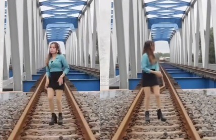 Viral wanita joget di atas rel hampir disambar kereta api (sumber tangkapan layar)