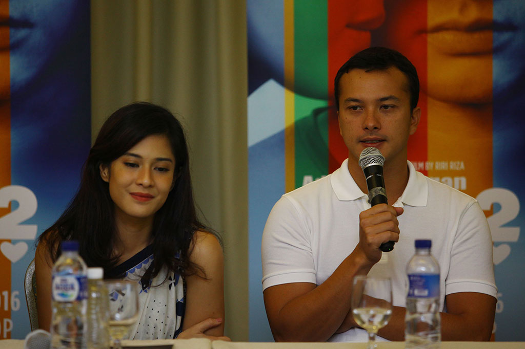 Pemain film AADC 2 Dian Sastrowardoyo (kiri) dan Nicholas Saputra (kanan) menjawab pertanyaan wartawan saat jumpa pers. 