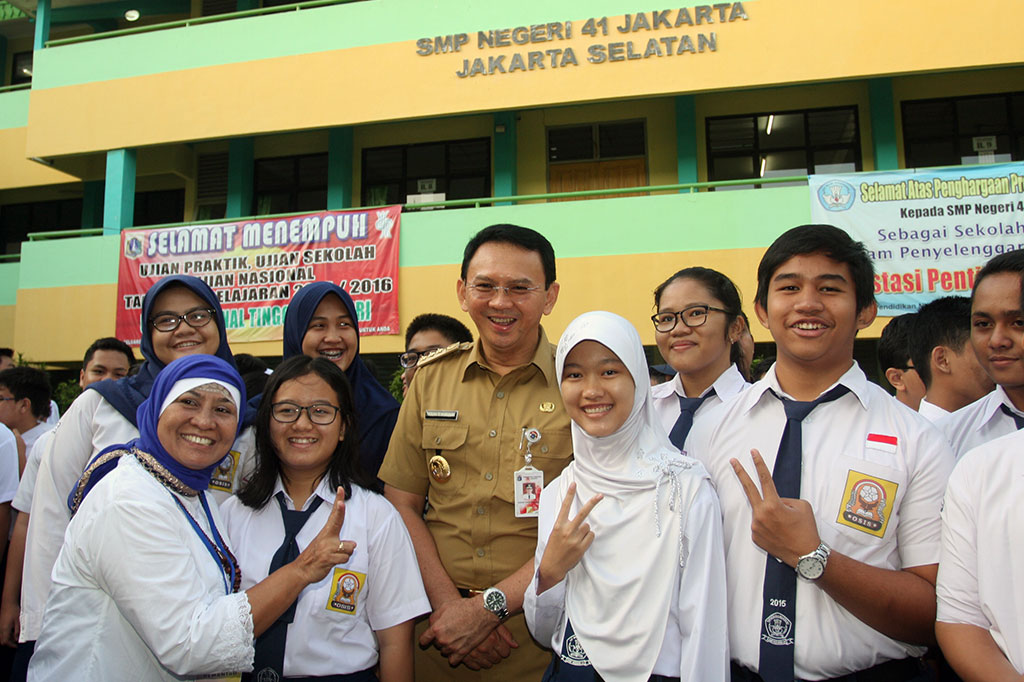 Ahok berfoto bersama dengan siswa dan guru saat meninjau pelaksanaan Ujian Nasional (UN) tingkat SMP di SMPN 41 Jakarta.