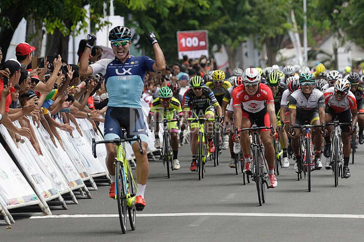 Atlet balap sepeda Korea dari tim LX-IIBS Cycling Team Shin Donghyun meluapkan kegembiraan saat menyentuh garis finish.