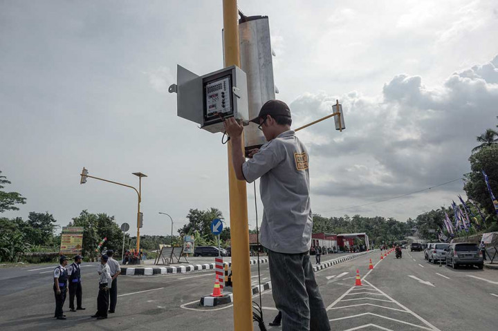 Petugas memasang lampu pengatur lalu lintas jalur lingkar Sumpiuh di Simpang Tambak, Banyumas.