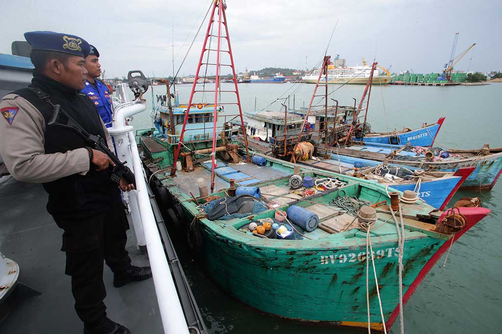 Anggota Satpolair Polda Kepri menjaga empat kapal yang berhasil diamankan, di Pelabuhan Batuampar, Batam, Kepulauan Riau, Jumat (24/6/2016).