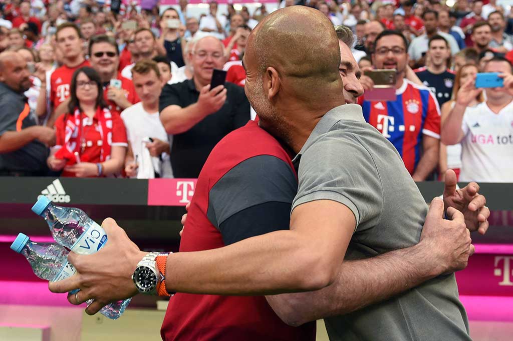 Manajer Manchester City Pep Guardiola berpelukan dengan manajer Bayern Muenchen Carlo Ancelotti sebelum pertandingan berlangsung.