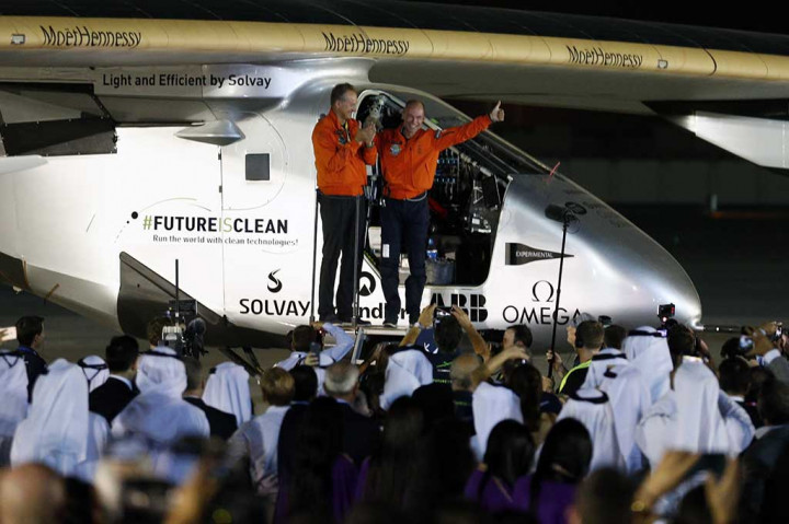 Pilot Bertrand Piccard dan Andre Borschberg melambaikan tangan saat keluar dari Solar Impulse 2 di Bandara Al Batin.