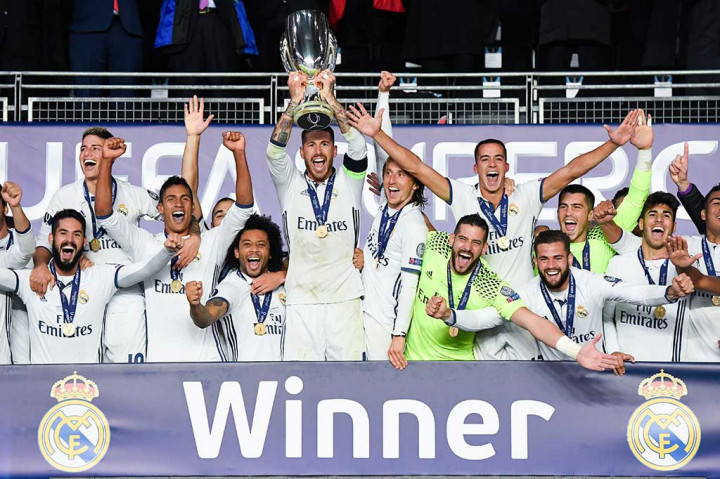 Para pemain Real Madrid melakukan selebrasi bersama trofi Piala Super Eropa yang baru saja mereka raih.