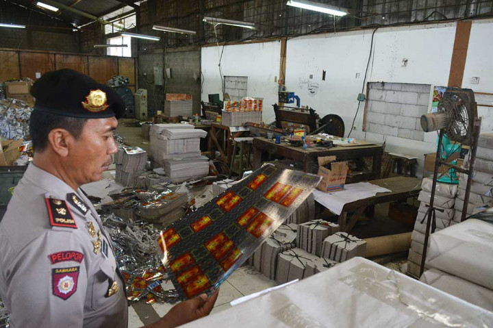 Seorang Polisi memeriksa bahan baku produksi jamu ilegal di Pasar Kemis.
