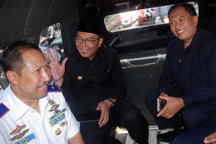 Ridwan Kamil didampingi Wakil Wali Kota Bandung Oded M Danial (kanan) dan Kadishub Jabar Dedi (kiri) naik angkutan kota (angkot) seusai Peluncuran Jumat Ngangkot.