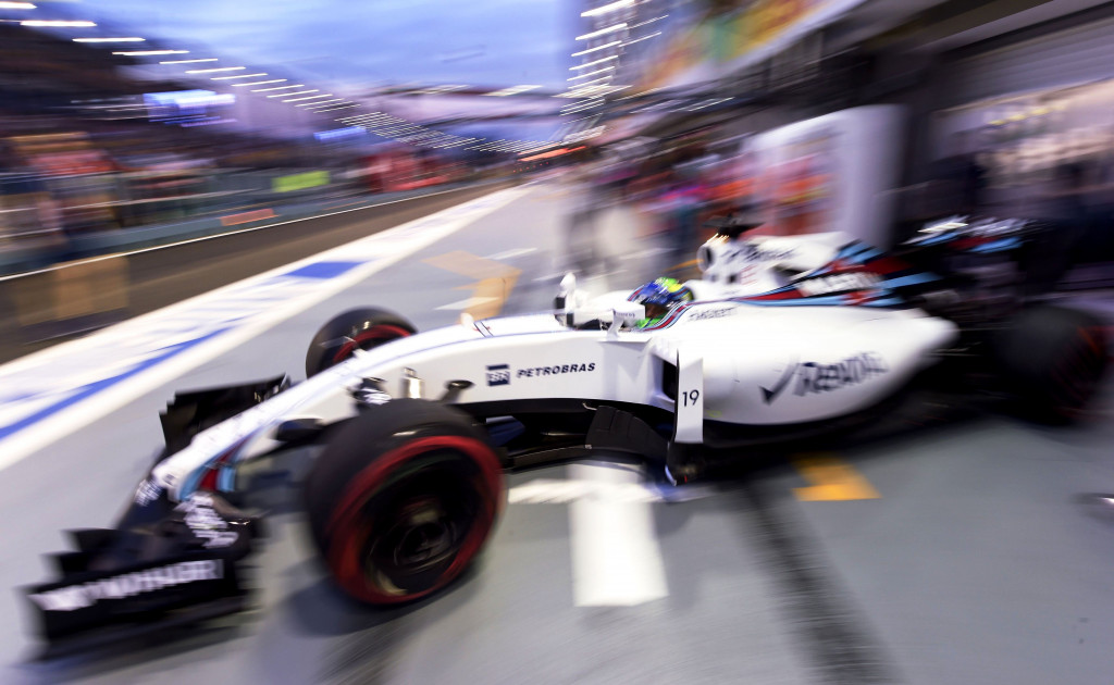 Felipe Massa mengeluarkan mobil Williams Martini Racing dari paddock menuju sirkuit jalan raya Marina Bay untuk berlatih. AFP PHOTO / Anthony WALLACE