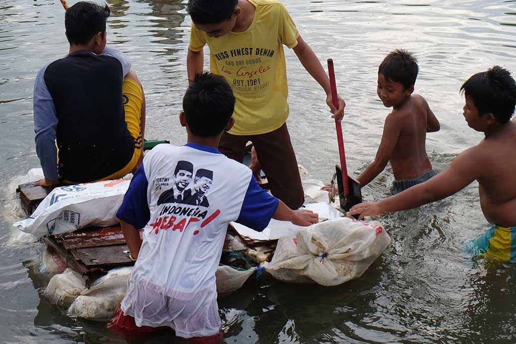 Anak-anak bermain di genangan air saat rob di Kecamatan Medan Labuhan, Medan, Selasa (20/9/2016).